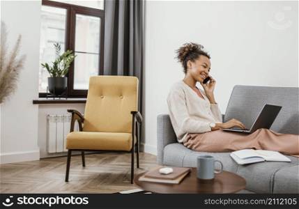 woman working while sitting sofa