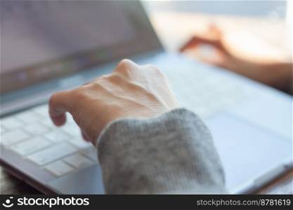 Woman working with a laptop, stock photo