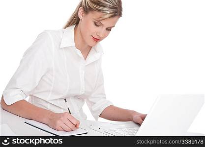 Woman working with laptop and writing notes on white background