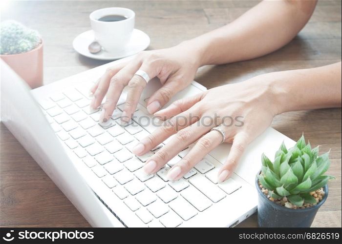 Woman working with laptop computer at home