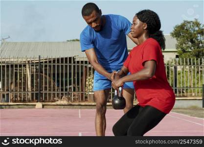 woman working with personal trainer