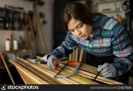 woman working workshop with measuring tape