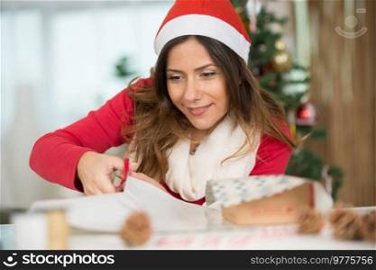 woman wrapping christmas gift box