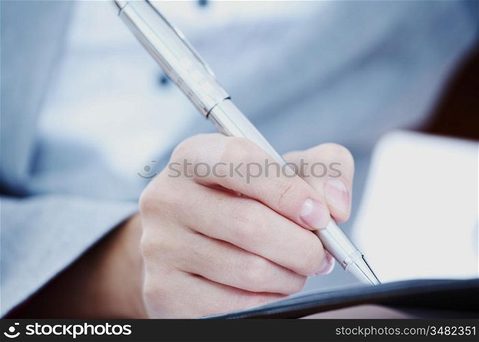woman write by pen close up