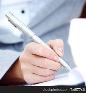 woman write by pen on paper