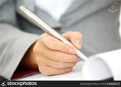 woman write by pen on paper