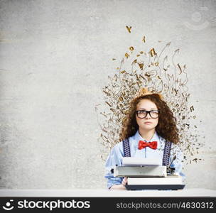 Woman writer. Young funny woman in glasses using typewriter