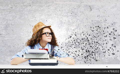 Woman writer. Young funny woman in glasses using typewriter