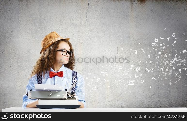 Woman writer. Young funny woman in glasses using typewriter