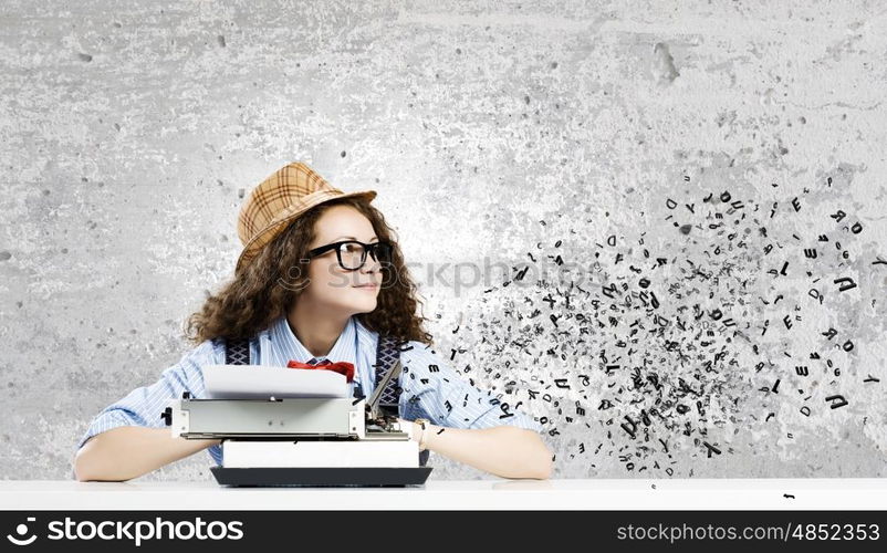 Woman writer. Young funny woman in glasses using typewriter