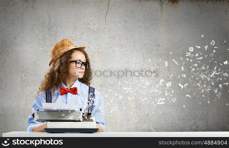 Woman writer. Young funny woman in glasses using typewriter