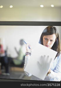 woman writing against window