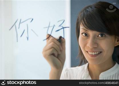 Woman writing hello in Chinese