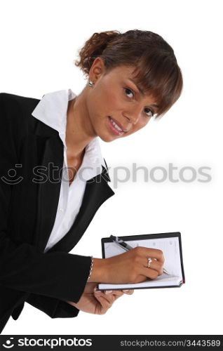 Woman writing in her agenda
