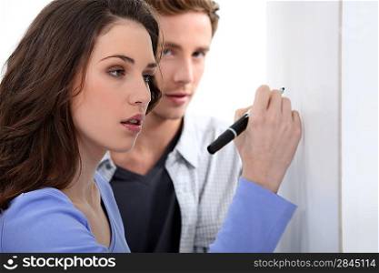 Woman writing on blank poster