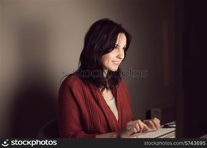 Woman writting on online chat at night