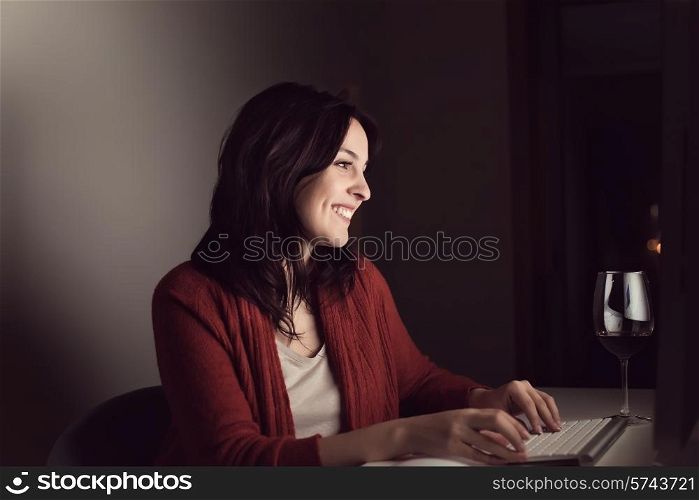 Woman writting on online chat at night