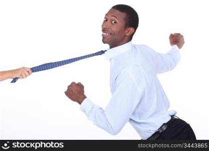 Woman yanking a man across shot by his tie