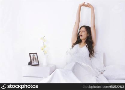 Woman yawning in bed