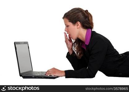 Woman yawning in front of a computer