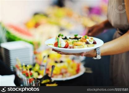 womanl chooses tasty meal in buffet at hotel banquet party restaurant