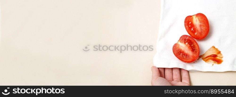 womans hand hold white shirt clothes with Tomatoes and ketchup stain.. womans hand hold white shirt clothes with Tomatoes and ketchup stain. banner