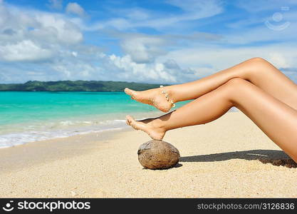 Women&acute;s beautiful legs on the beach