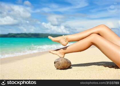 Women&acute;s beautiful legs on the beach