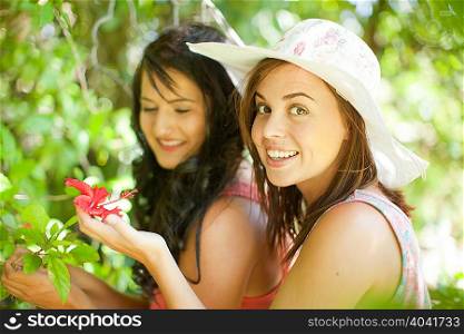 Women admiring flowers in park