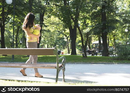 Women and baby in a park. Sunny day