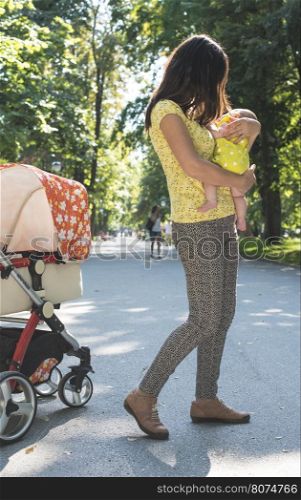 Women and baby in a park. Sunny day