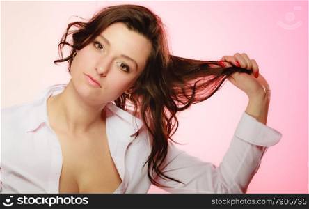 Women and beauty. Portrait of sexy brunette girl long hair on pink