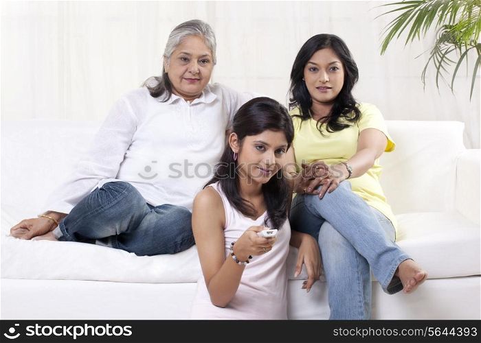 Women and girl watching television