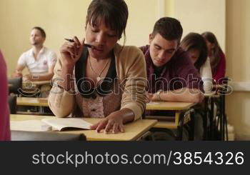 Women and men at school, group of young students during test in college class