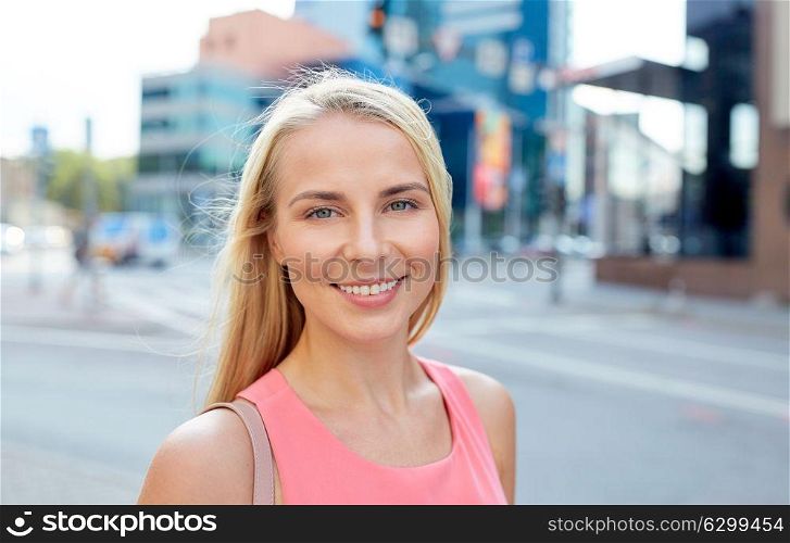 women and people concept - happy smiling young woman on city street. happy smiling young woman on city street