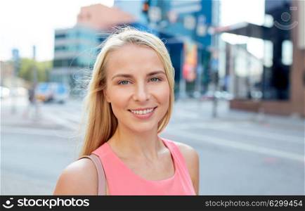 women and people concept - happy smiling young woman on city street. happy smiling young woman on city street