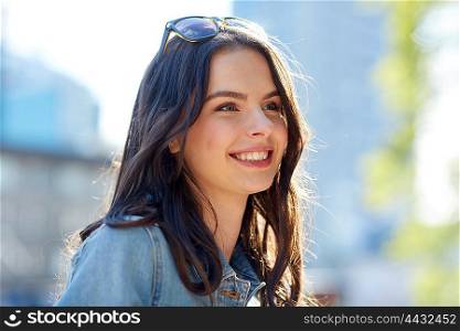 women and people concept - happy smiling young woman on summer city street. happy smiling young woman on summer city street