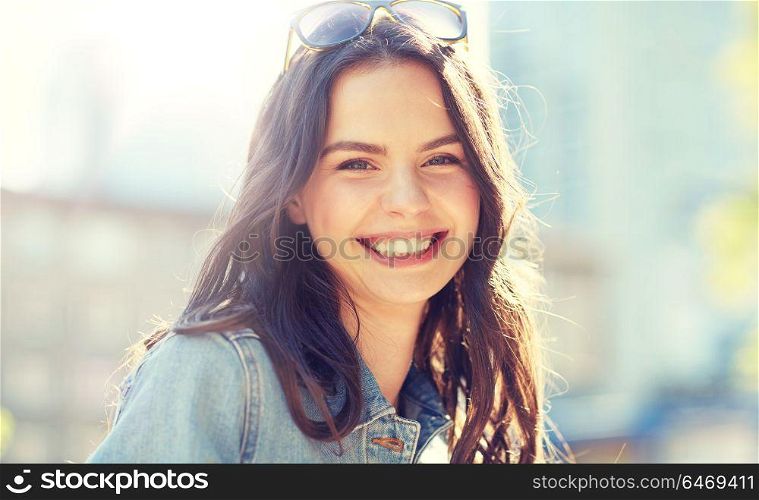 women and people concept - happy smiling young woman on summer city street. happy smiling young woman on summer city street