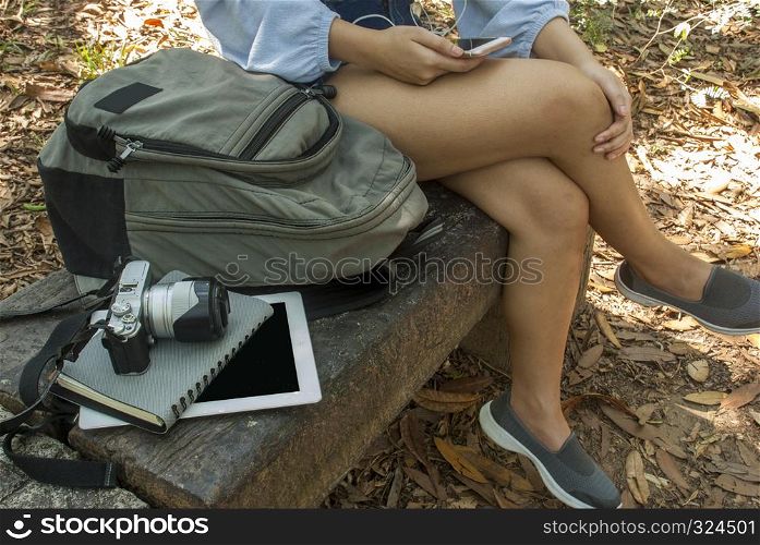 Women are listening to music while taking a break from walking in the park.