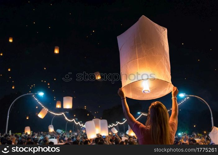 Women are releasing floating lanterns in the Loy Krathong festival or floating lanterns festival in Chiang Mai, Thailand.. Floating lanterns Festival