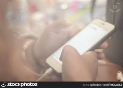 Women are using smartphones play social media on desks vintage tones, soft focus