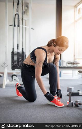 women asian tying shoe laces. fitness women getting ready for engage in the gym