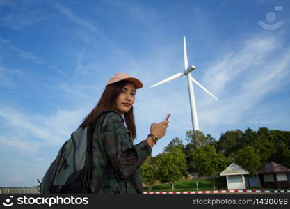 women asian with bright backpack for the tourist traveler and Female hands using smartphone