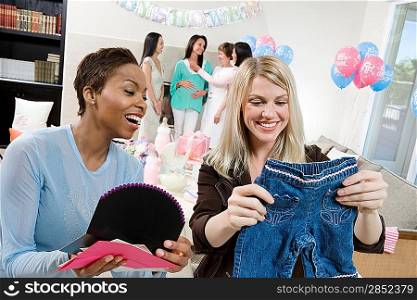 Women at a Baby Shower with baby Clothes