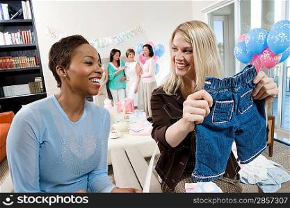 Women at a Baby Shower with baby Clothes