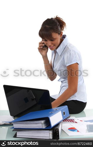 Women at the phone sitting on the table