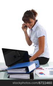 Women at the phone sitting on the table