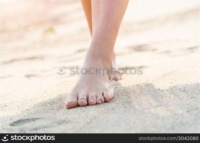 women barefoot walking on the white sand nature on the beach. su. women barefoot walking on the white sand nature on the beach. summer trip