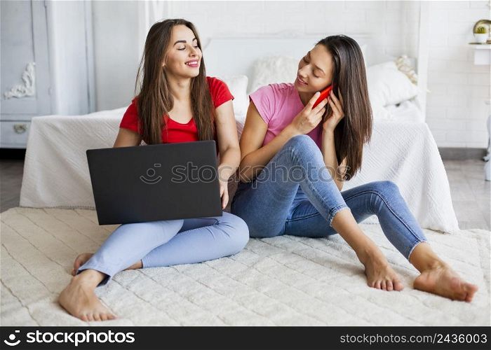 women bed using laptop talking phone