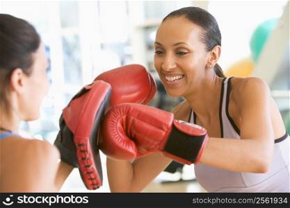 Women Boxing Together At Gym
